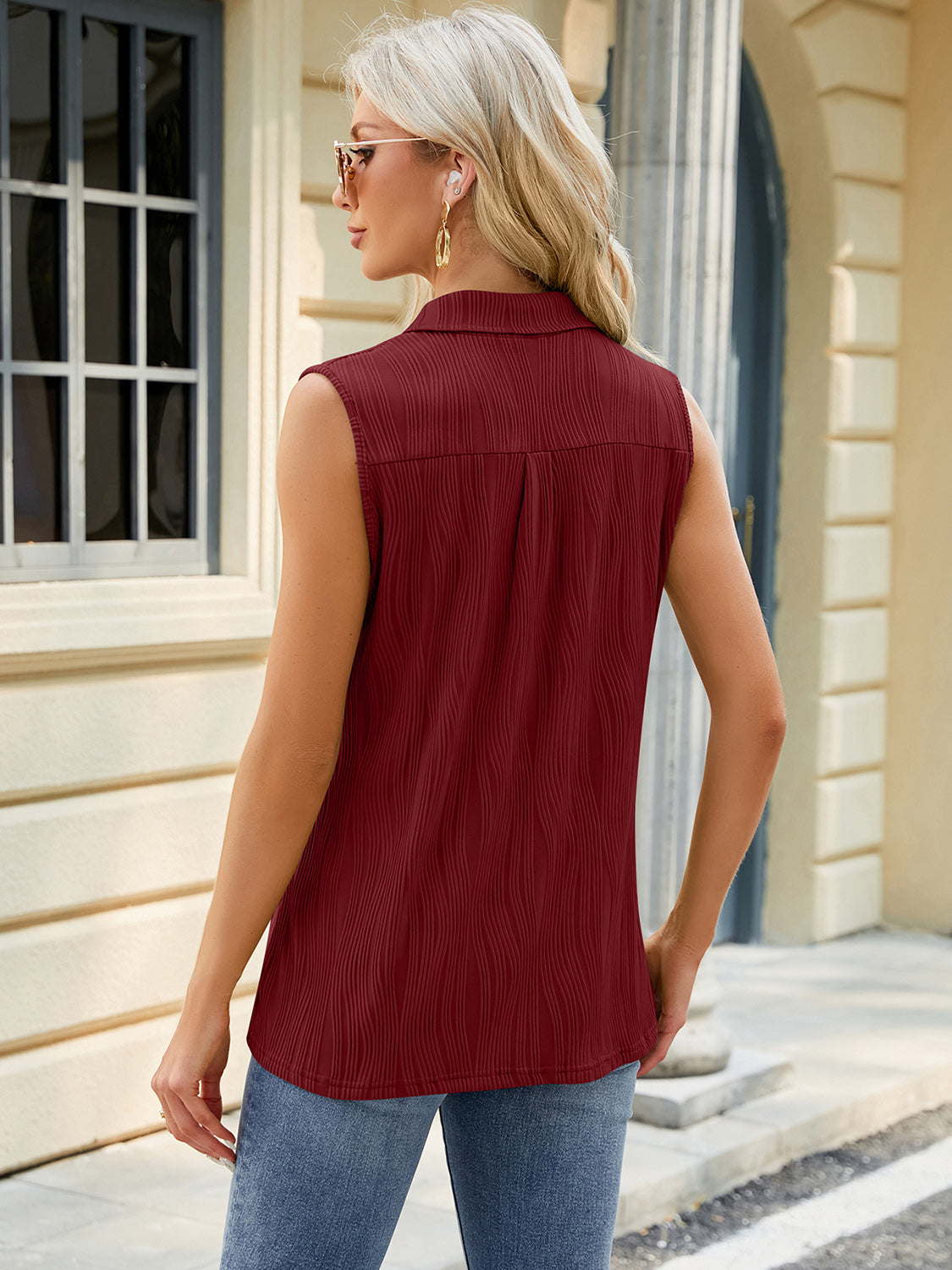 Burgundy textured collared sleeveless blouse with vertical ribbing detail.