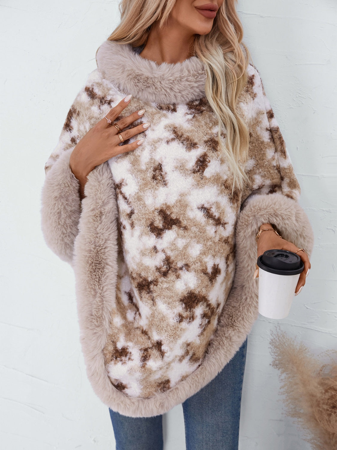 Faux fur trimmed camo poncho in Chocolate with a cozy cowl neck and relaxed fit.