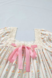 Floral mini dress with lace trim, square neck, pink bow detail, and puff sleeves.