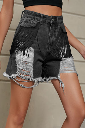 Black distressed denim shorts with fringe pockets and raw hem.