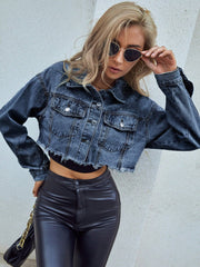 Cropped denim trucker jacket in medium wash with raw hem and distressed details.