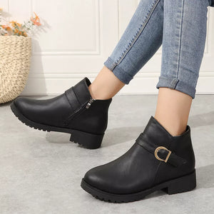 Black ankle boots with side zipper and gold buckle detail, block heel.
