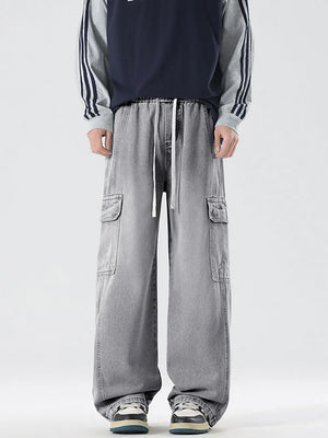 Light gray oversized cargo jeans with drawstring waist and large side pockets.