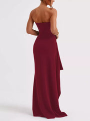 Burgundy strapless maxi dress with ruching and high slit detail.