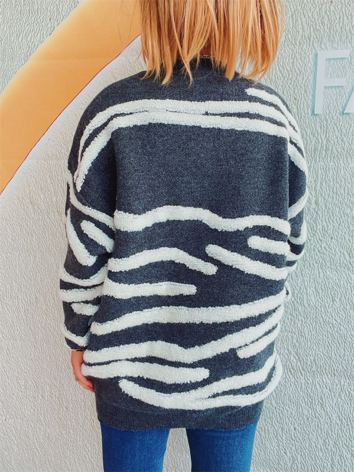 Textured stripe knit crewneck sweater in dark gray with white fuzzy stripes.