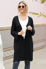 Black textured open-front maxi knit cardigan with a V-neck and bell sleeves.