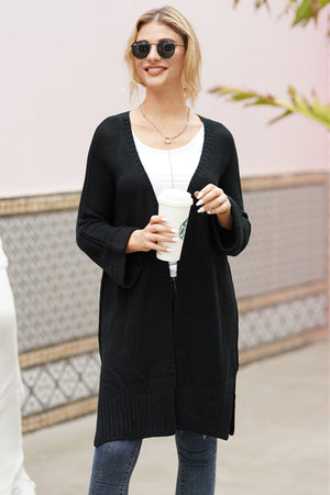 Black textured open-front maxi knit cardigan with a V-neck and bell sleeves.