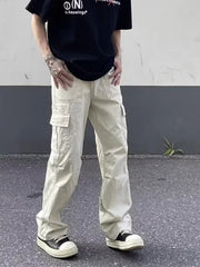 Men's beige cotton relaxed fit utility cargo pants with multiple pockets.