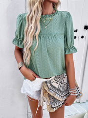 Light green eyelet puff sleeve blouse with ruffled cuffs and neckline.