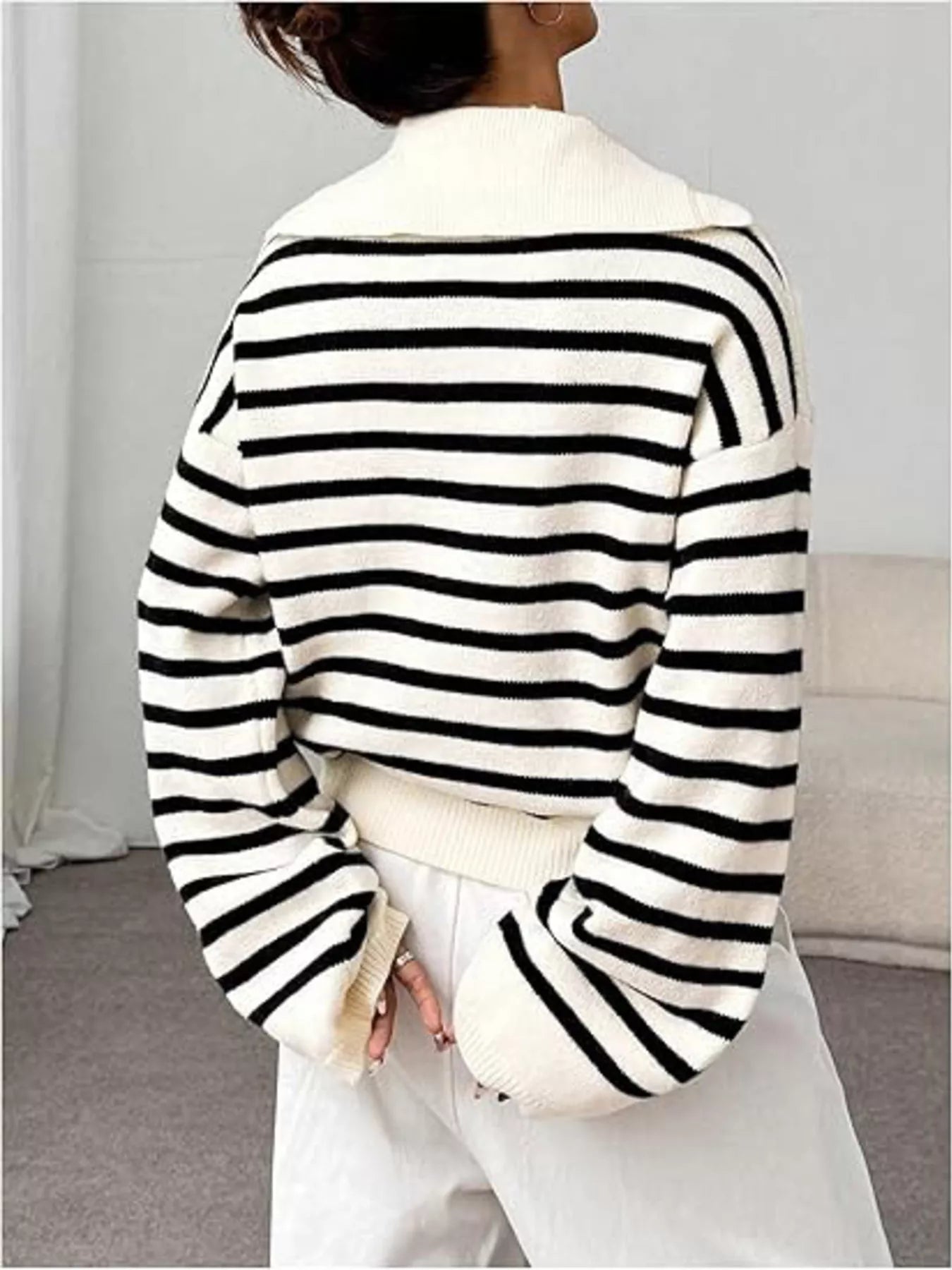 Black and white striped long-sleeve sweater with a spread collar and ribbed cuffs.