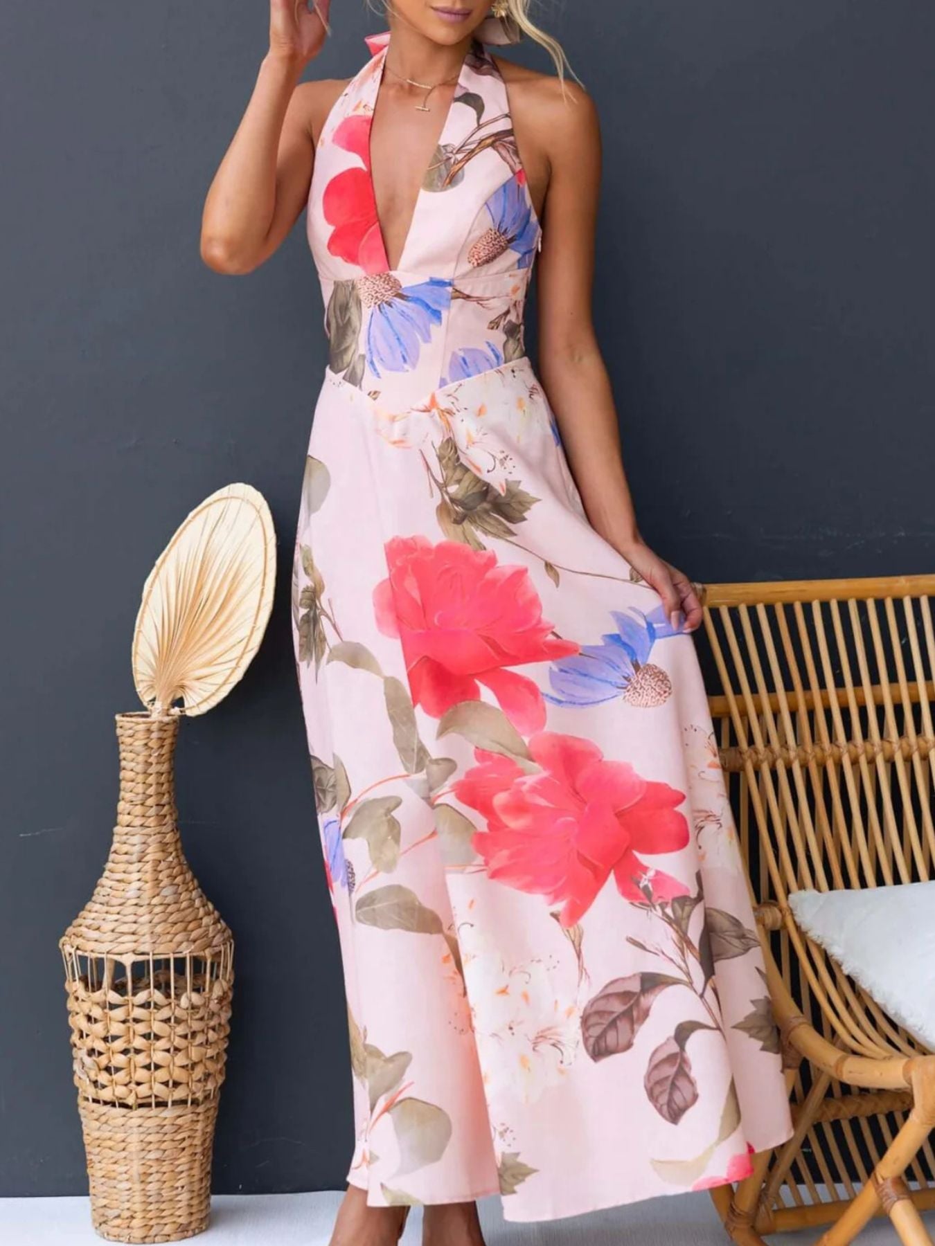 Pink floral halter neck maxi dress with a deep V-neck and a-line skirt.