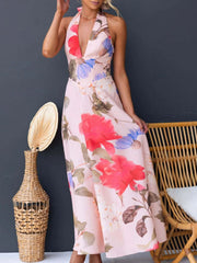 Pink floral halter neck maxi dress with a deep V-neck and a-line skirt.