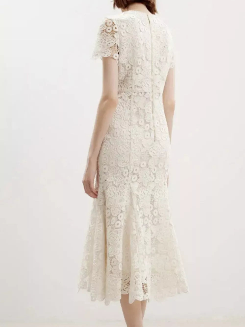 Cream floral lace mermaid evening gown with cap sleeves and a flared hem.