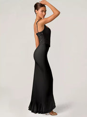 Black sequin ruffle maxi gown with spaghetti straps and a mermaid skirt.