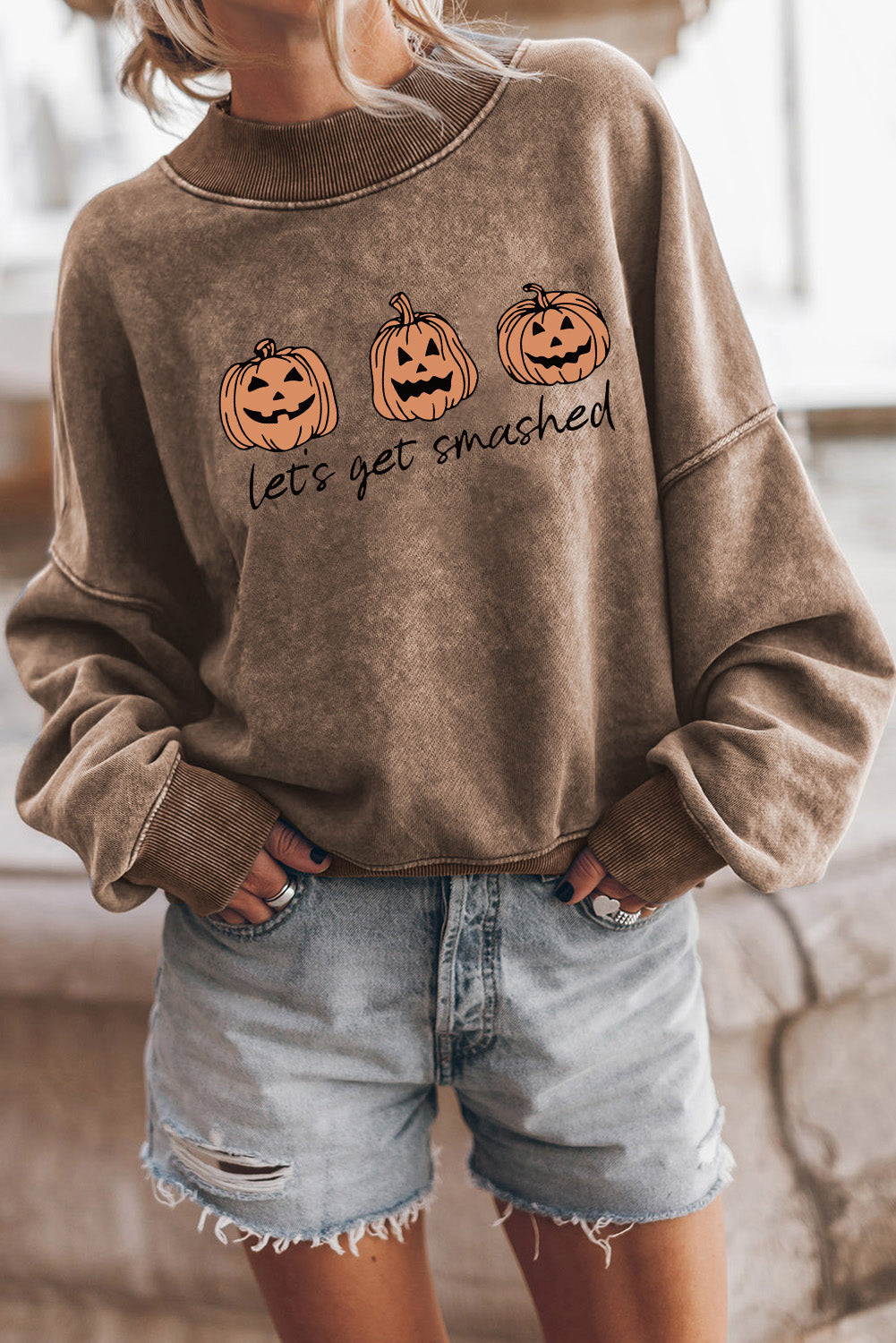 Acid wash camel crewneck sweatshirt with pumpkin graphic and text.