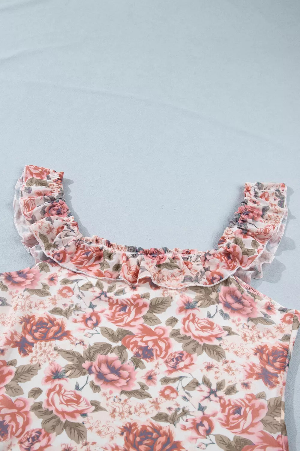 Floral ruffle-trimmed tank top with a square neckline and sheer ruffled straps.
