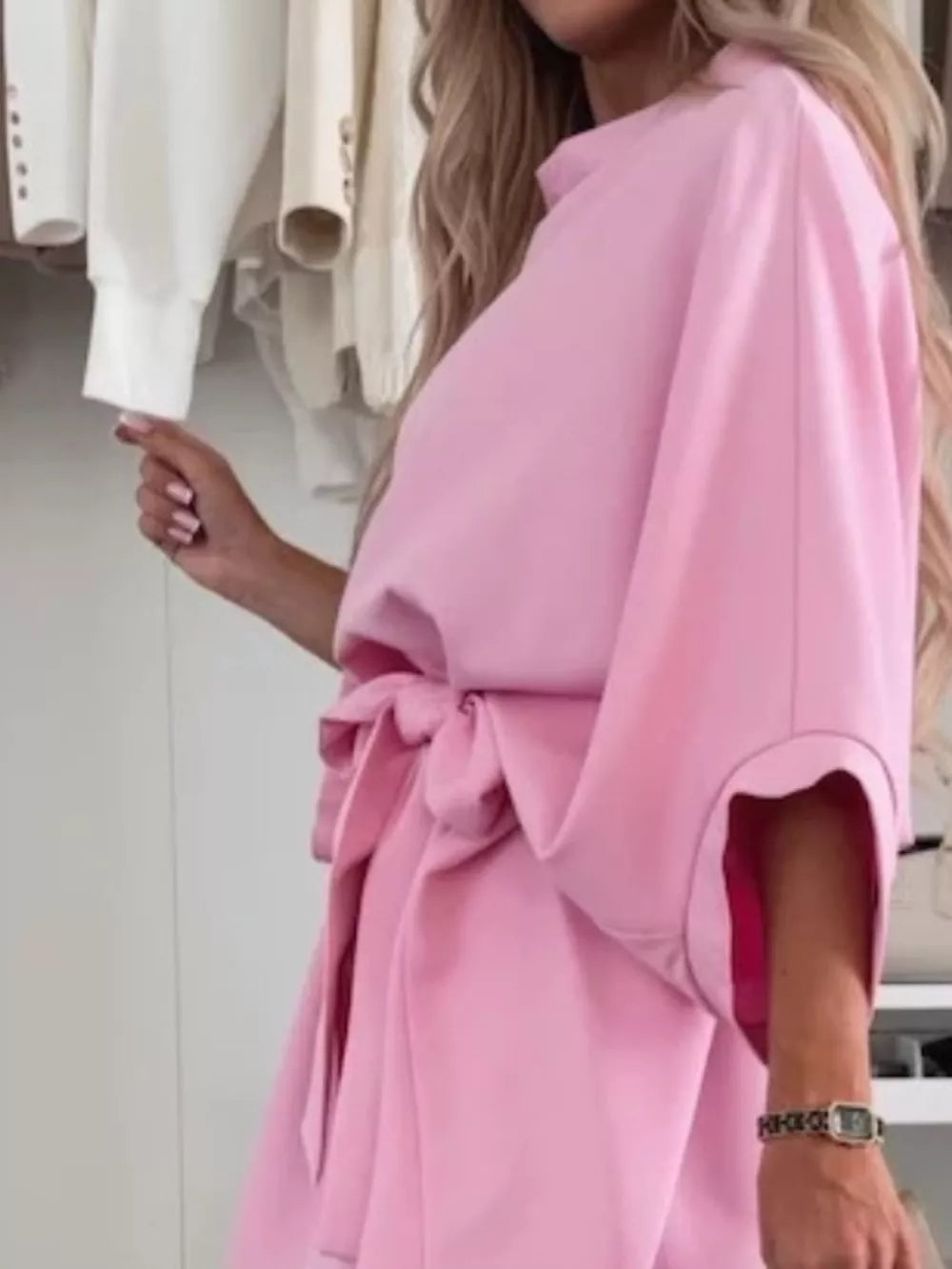 Pink batwing sleeve mini dress with tie waist and wide cuffs.