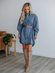 Medium wash denim oversized shirtdress with button front, balloon sleeves, and side slits.