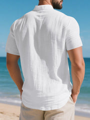 White short sleeve henley shirt with band collar and textured cotton fabric.