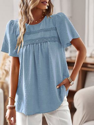 Light blue textured puff sleeve blouse with lace yoke detail and short sleeves.