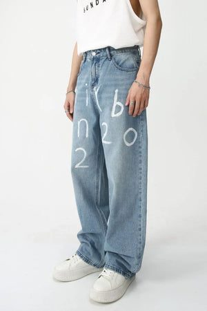 Painted script baggy jeans in medium wash denim with white graphic print.