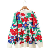 Floral intarsia crewneck knit sweater in white with red, blue, and green abstract floral pattern.