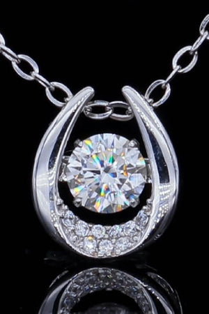 Silver necklace with a central diamond and a halo of smaller diamonds in a horseshoe-shaped pendant.