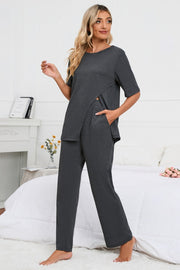 Dark gray loungewear set with asymmetric slit tee and wide leg pants.