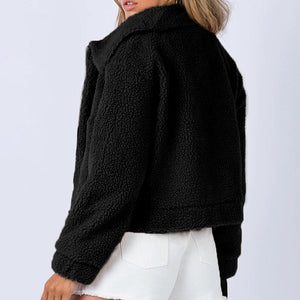 Black textured sherpa jacket with a cropped collar and relaxed fit.