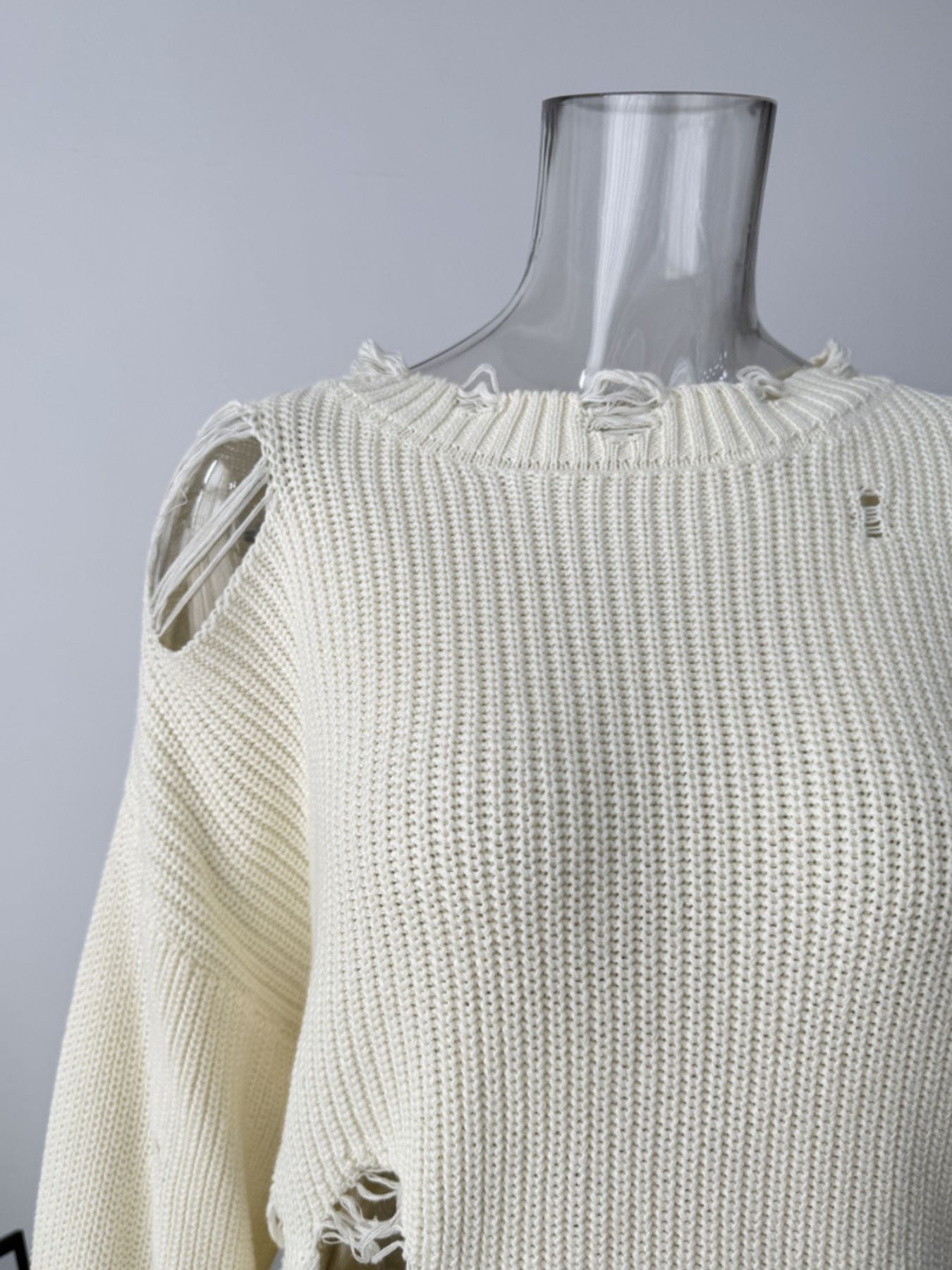Off white distressed cotton sweater with ripped details and frayed neckline.