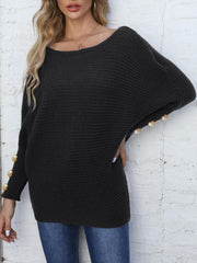 Black batwing knit sweater with pearl cuff details and boat neck.