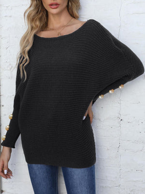 Black batwing knit sweater with pearl cuff details and boat neck.