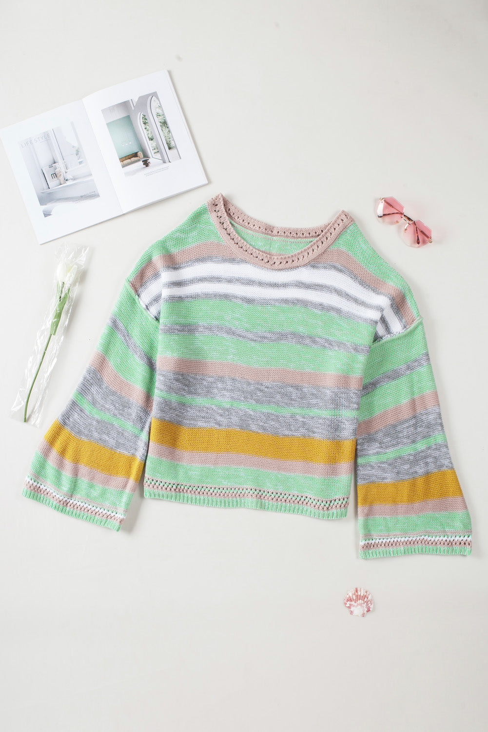 Open-shoulder stripe knit pullover in Gum Leaf with crochet neckline and bell sleeves.
