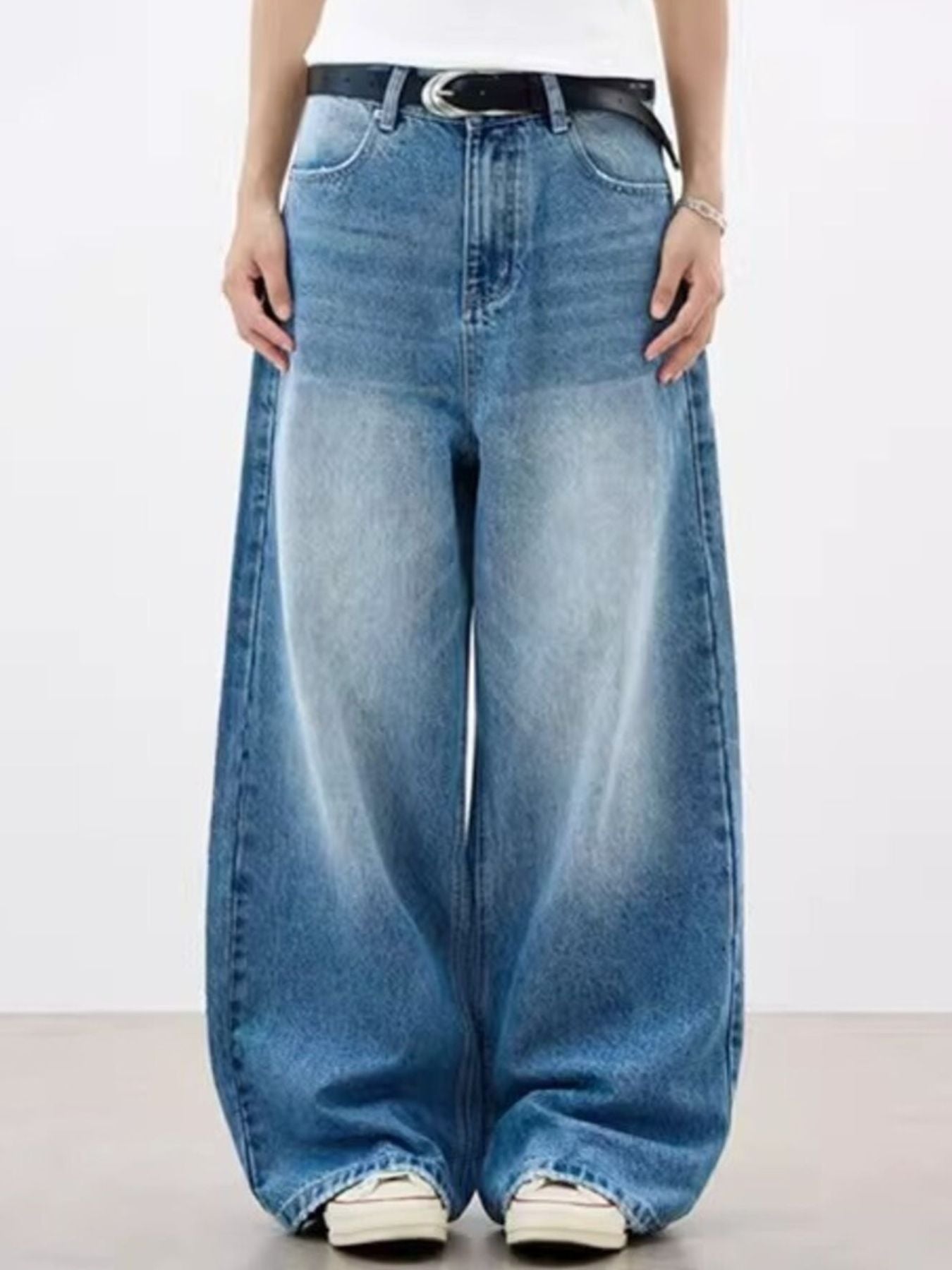 Relaxed fit vintage wash blue denim jeans with pockets and a baggy cut.
