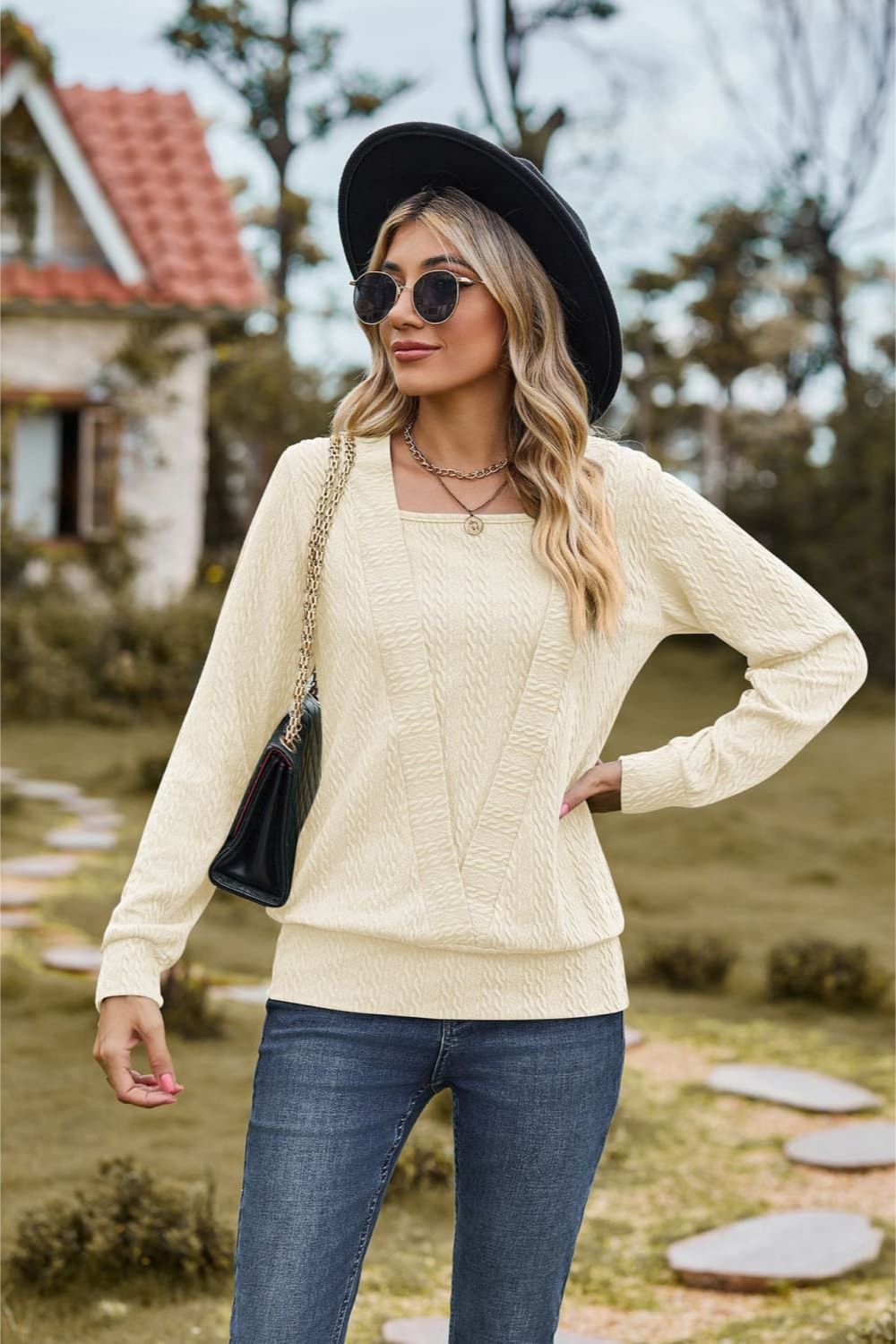 Ivory textured knit sweater with square neckline and long sleeves.