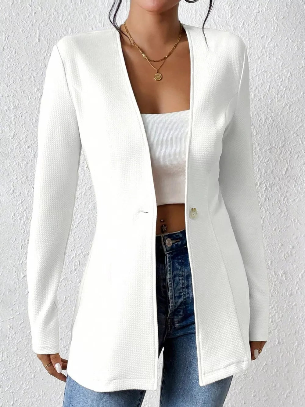 White single-button blazer with tailored fit and textured fabric.