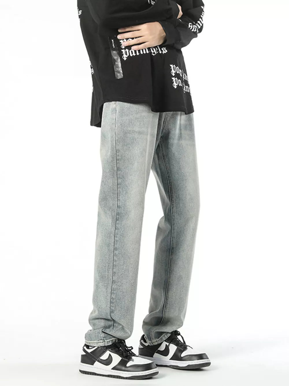 Classic loose fit vintage denim jeans in light wash cotton, styled with a black graphic tee.
