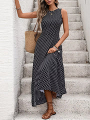 Black polka dot sleeveless maxi dress with a flattering silhouette and asymmetric hem.