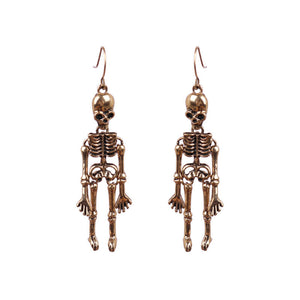 Skeleton silhouette drop earrings in gold alloy with articulated limbs.