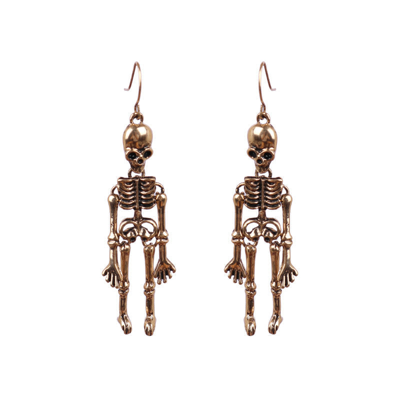 Skeleton silhouette drop earrings in gold alloy with articulated limbs.