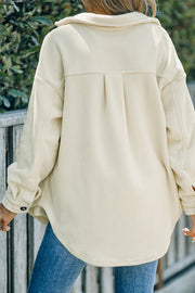 Cream fleece shirt jacket with back pleats and button cuff.