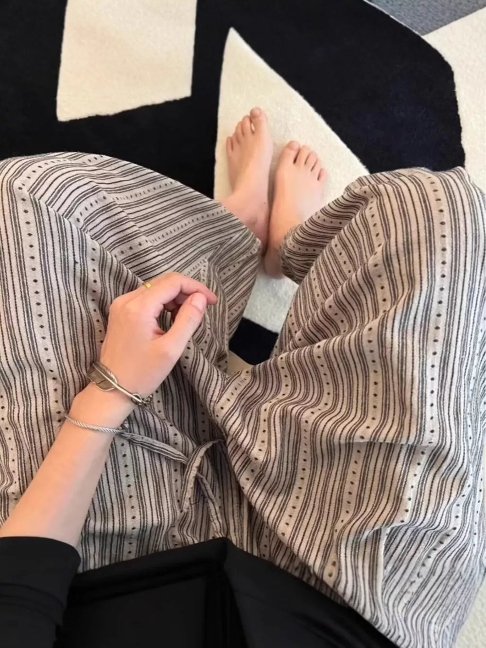 Men's wide-leg sweatpants with vertical stripes and dotted accents, featuring a drawstring waist.