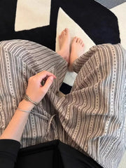 Men's wide-leg sweatpants with vertical stripes and dotted accents, featuring a drawstring waist.