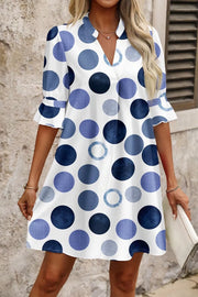 Chic blue polka dot mini dress with flounce sleeves and v-neck.