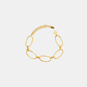 Gold elongated oval link bracelet with adjustable chain and clasp.