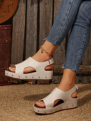 Cutout studded platform sandals in beige with peep toe and ankle strap.
