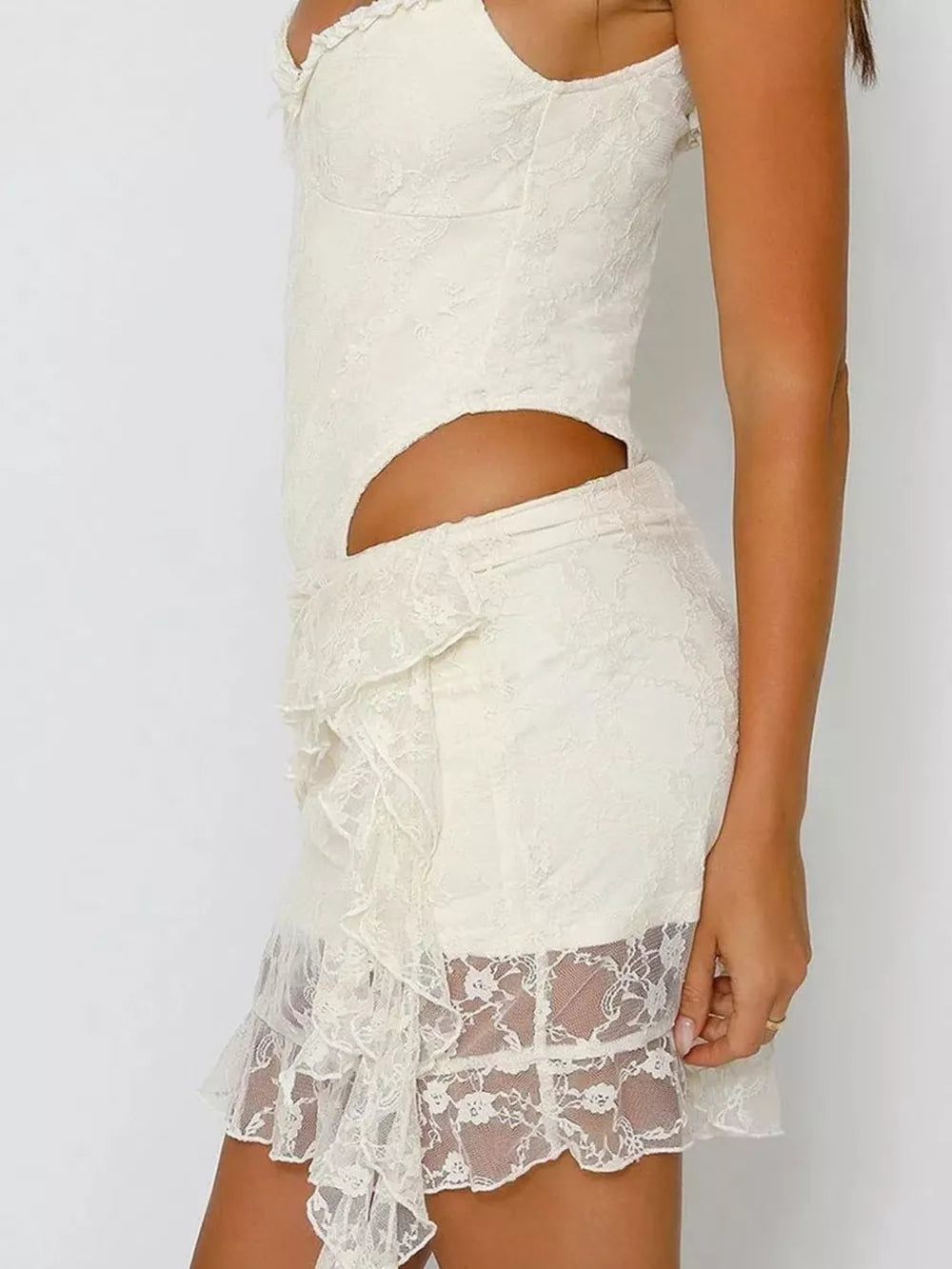 Lace ruffled mini skirt in ivory with asymmetrical ruffle detail and sheer lace hem.