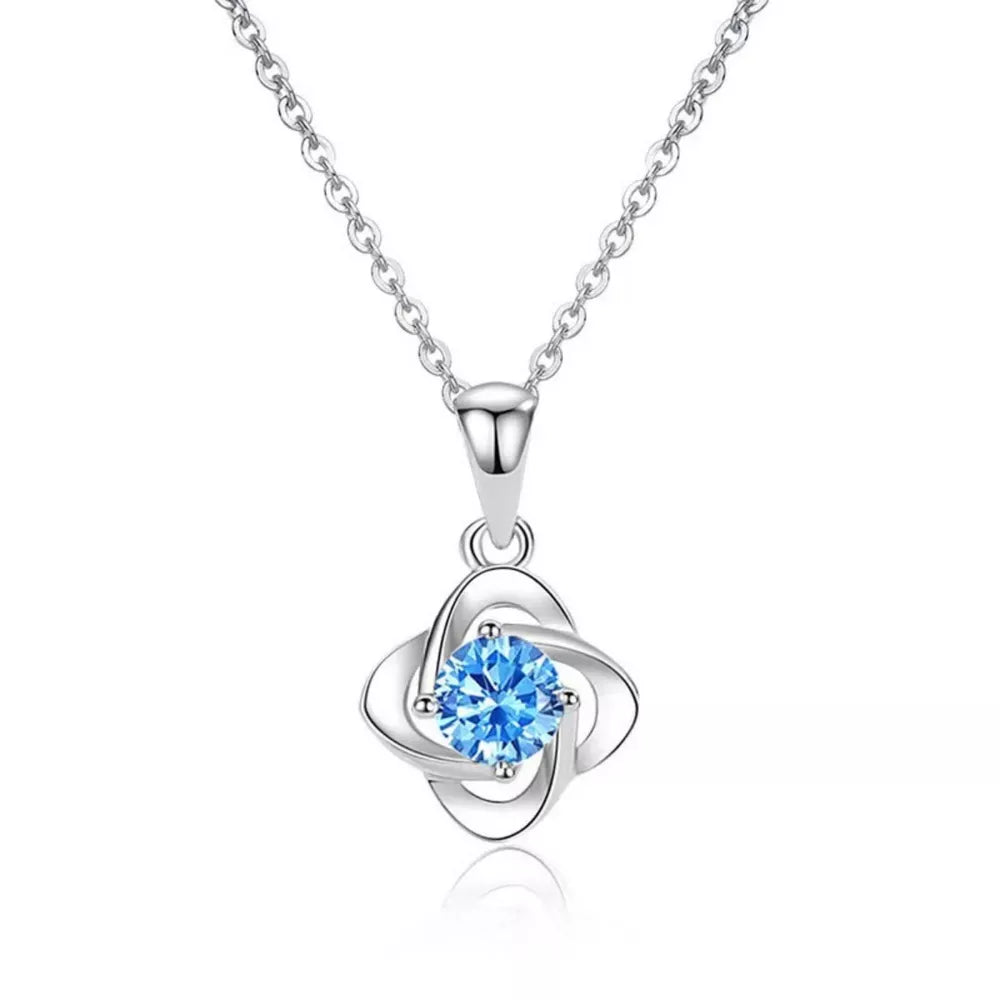 Delicate silver four-leaf clover necklace with blue crystal charm