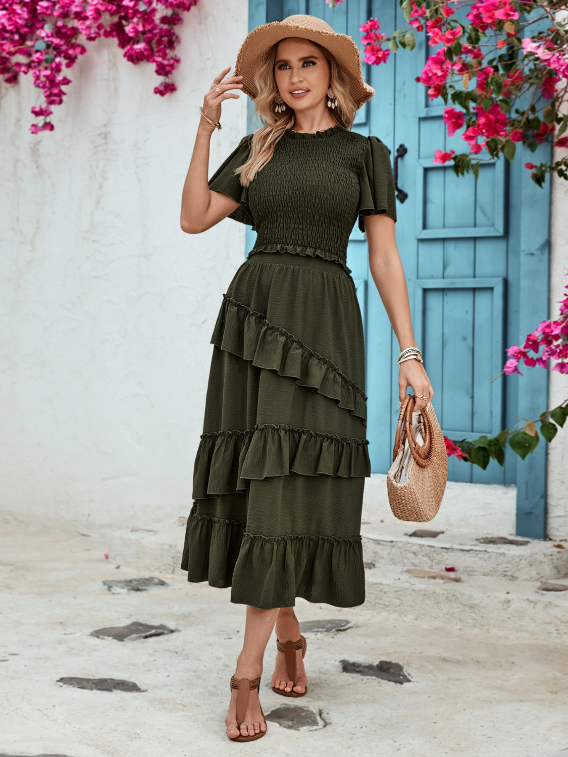 Tiered midi skirt in dark green with ruffled tiers and textured fabric.