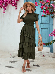 Tiered midi skirt in dark green with ruffled tiers and textured fabric.